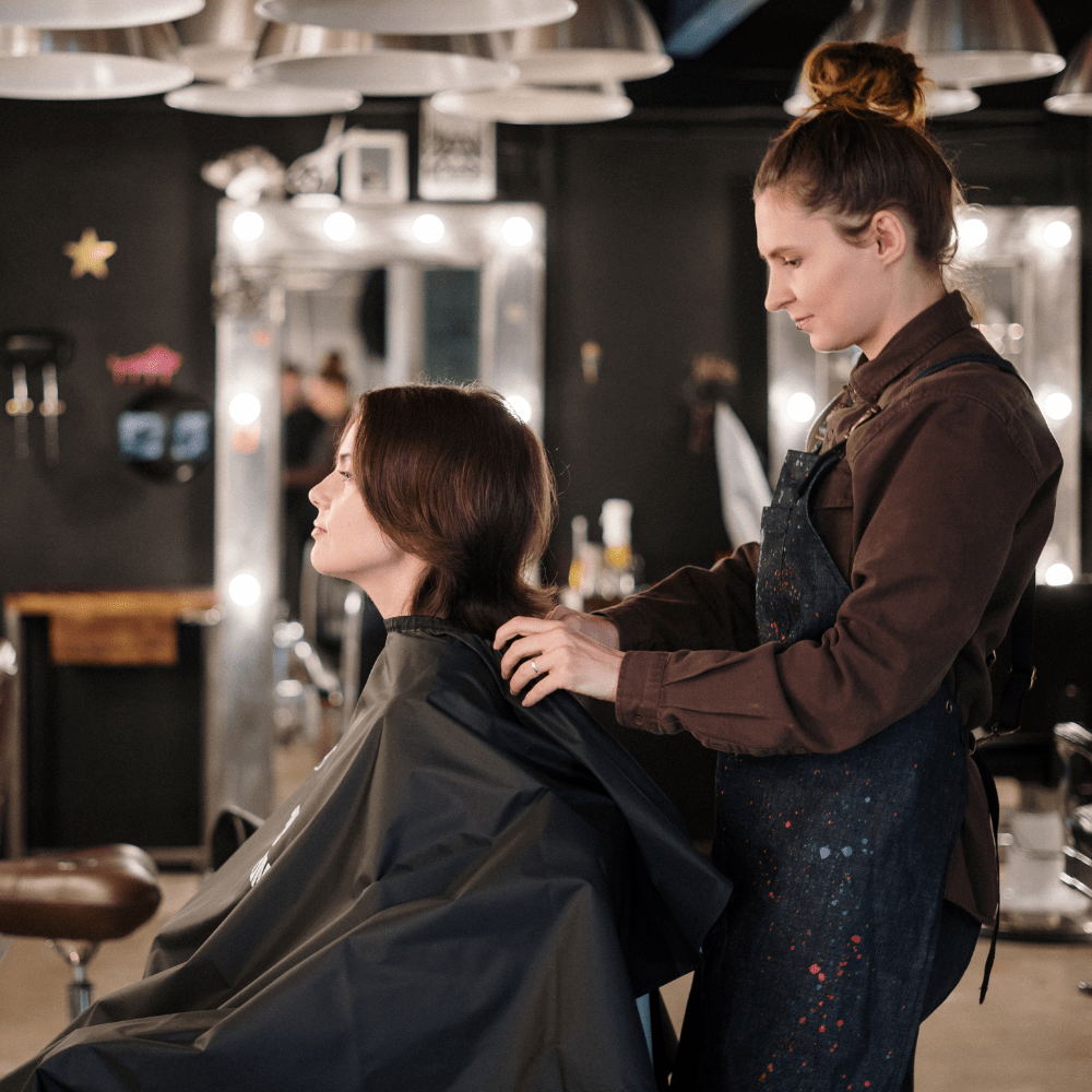 A client receiving a haircut at Kosa Salon SF