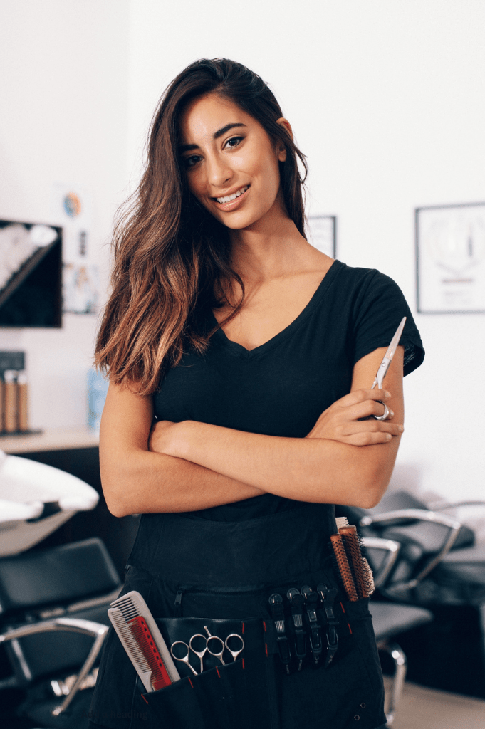Maya Delgado, female luxury hair extension expert at Salon 1150 in Austin, specializing in hand-tied and tape-in extensions for natural, voluminous looks.
