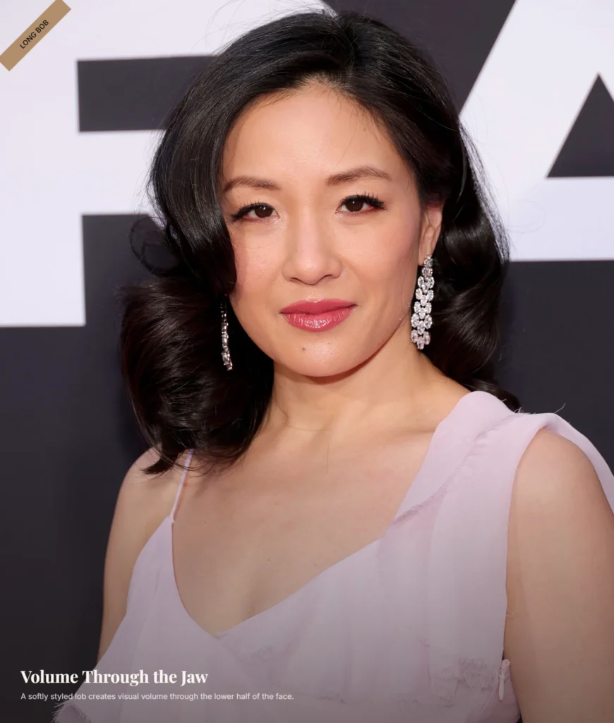 Woman with a heart-shaped face wearing a shoulder-length lob with volume around the jaw