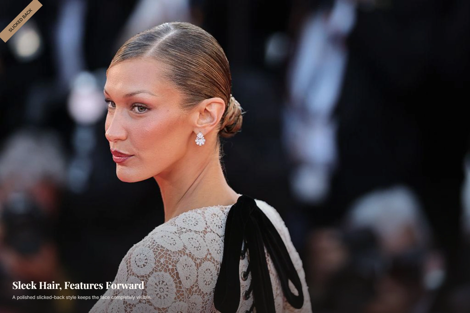 Woman with an oval face wearing a sleek slicked-back hairstyle with hair pulled away from her face
