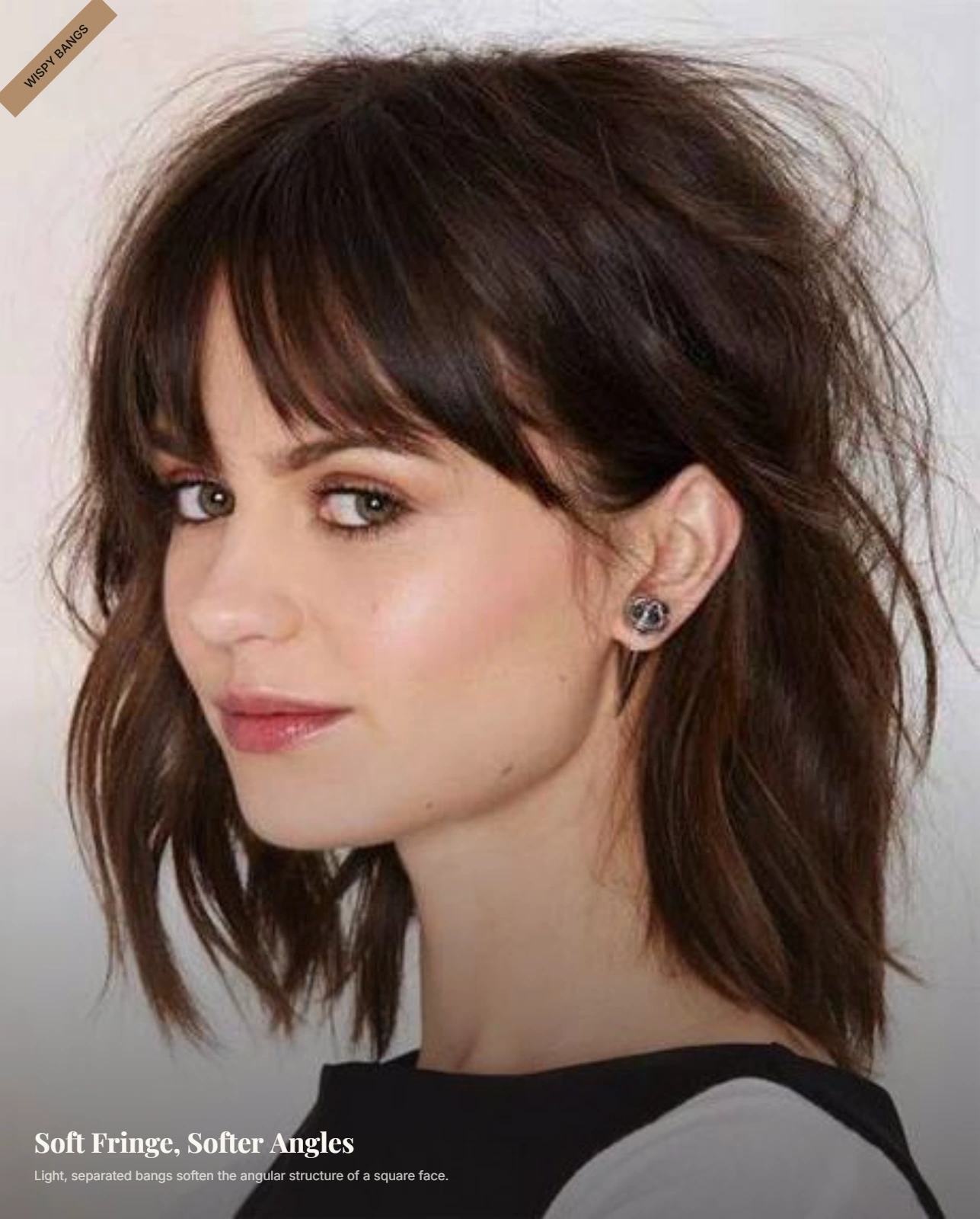 Woman with a square face wearing soft wispy bangs and light face-framing layers