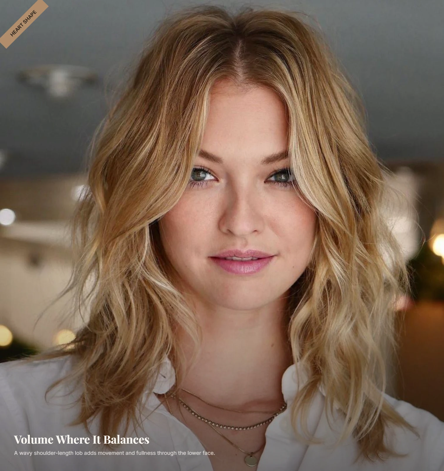 Woman with a heart-shaped face wearing a wavy shoulder-length lob with soft lower-face volume