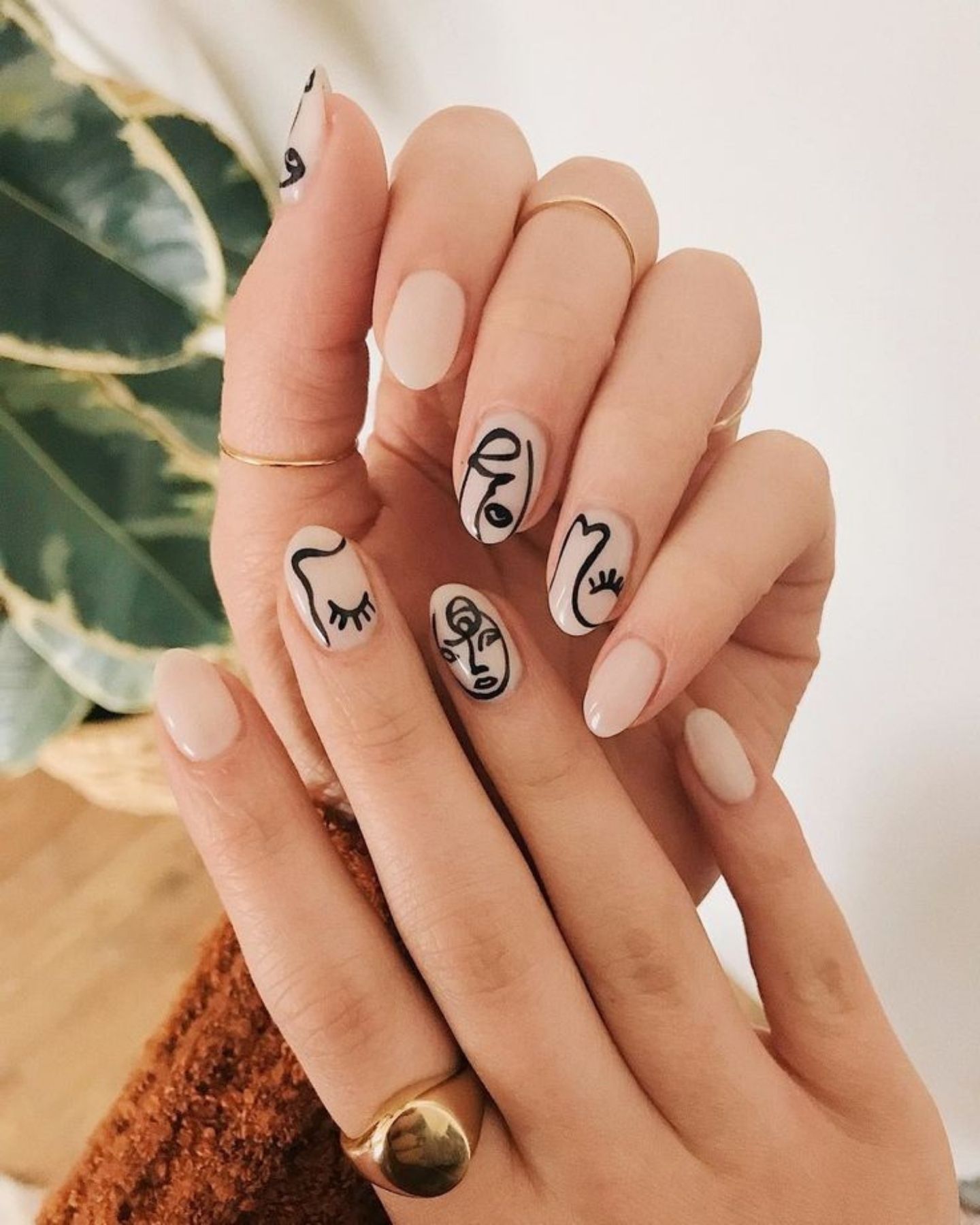 Abstract Nail Art Design featuring a nude base with creative blue, white, and purple abstract patterns, offering a serene and artistic touch for an elegant, minimalist look.