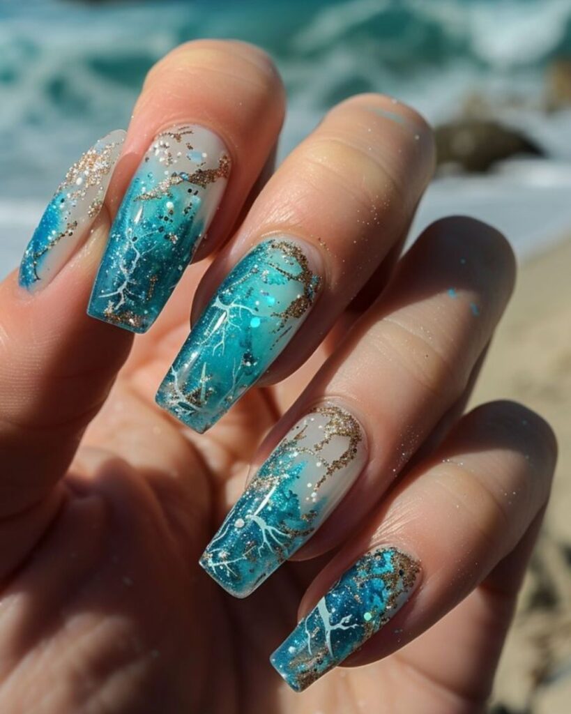 Blue Ocean Nail Art Design with long aqua gradient nails, gold glitter flakes, white crackle patterns, and silver sparkles for a beach-inspired look
