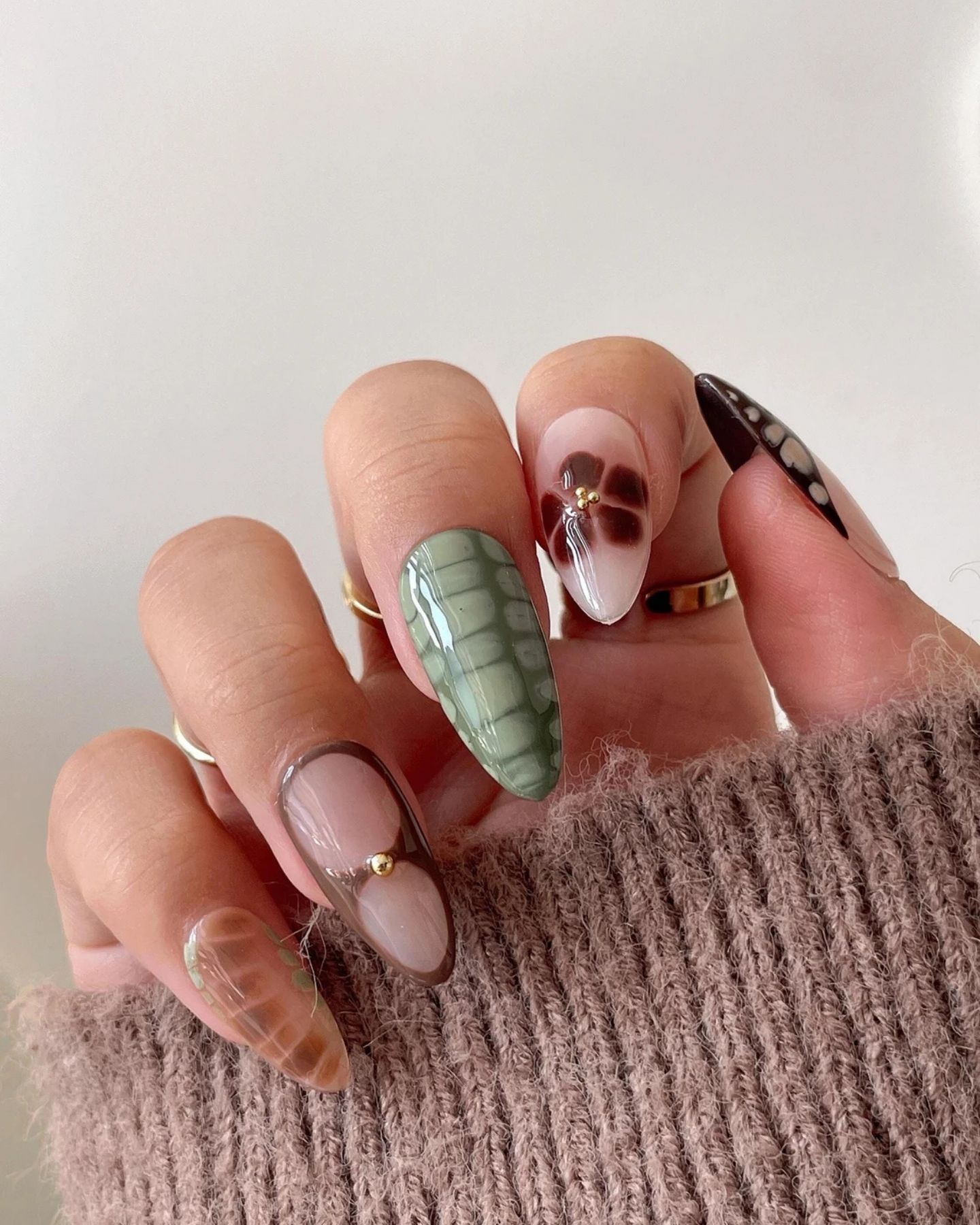 Close-up of CROC Nail Art Design on coffin-shaped nails, featuring bold blue crocodile skin patterns with unique variations on each nail for a daring and edgy fashion statement.