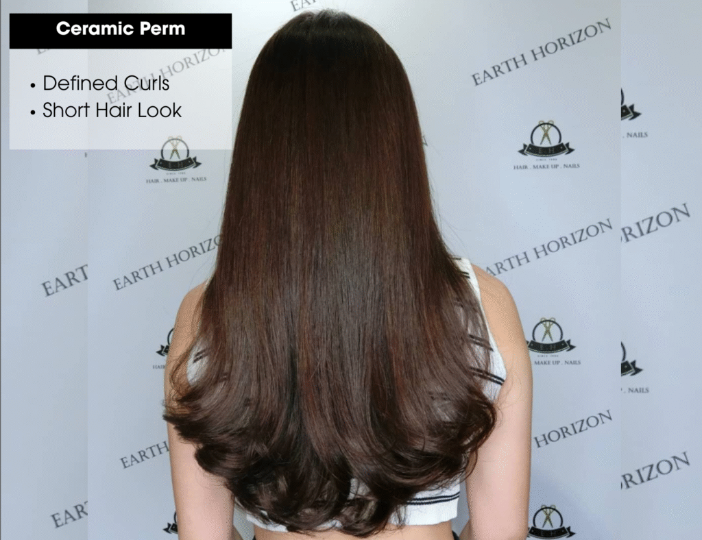 Ceramic perm creating defined, bouncy curls for a voluminous short hair look.