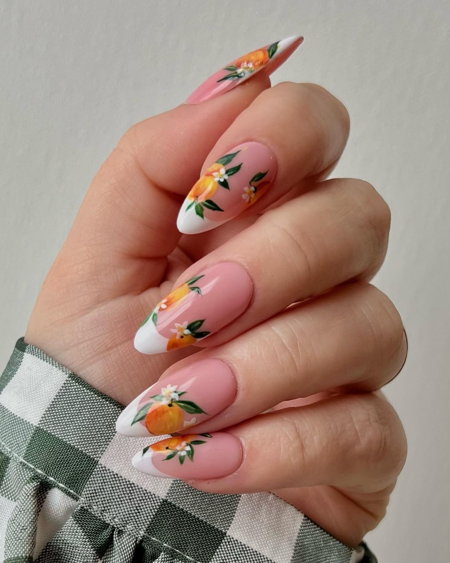 Close-up of fruity-themed French tips with vibrant spring colors, painted for a nail art competition entry