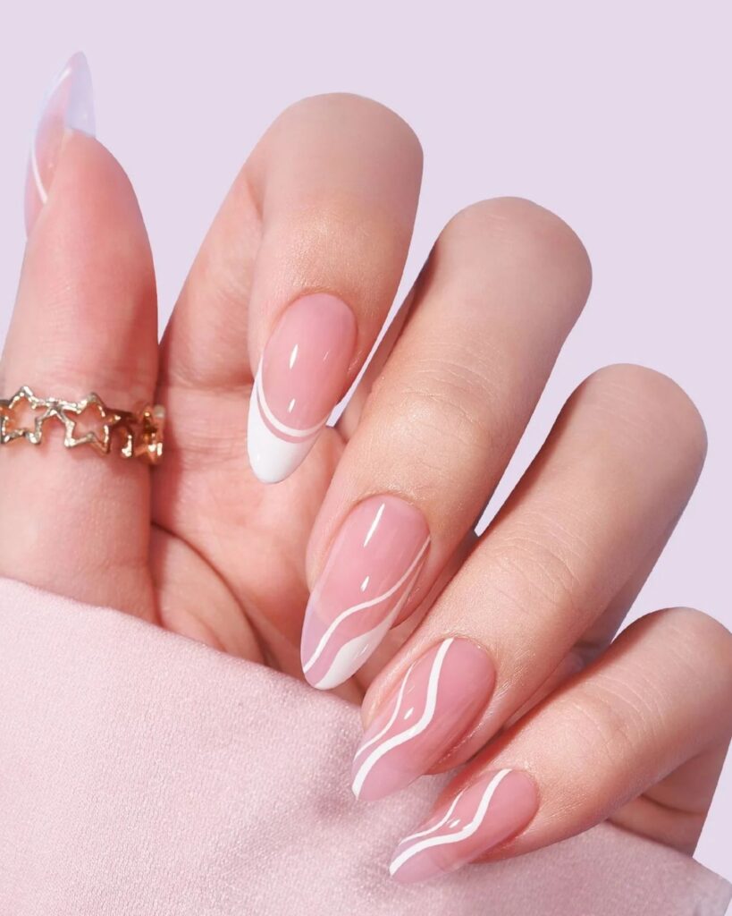 Close-up of Swirly French Nails with red and orange swirl patterns on classic French tips, combining playful color with a spring-inspired twist on a timeless design.