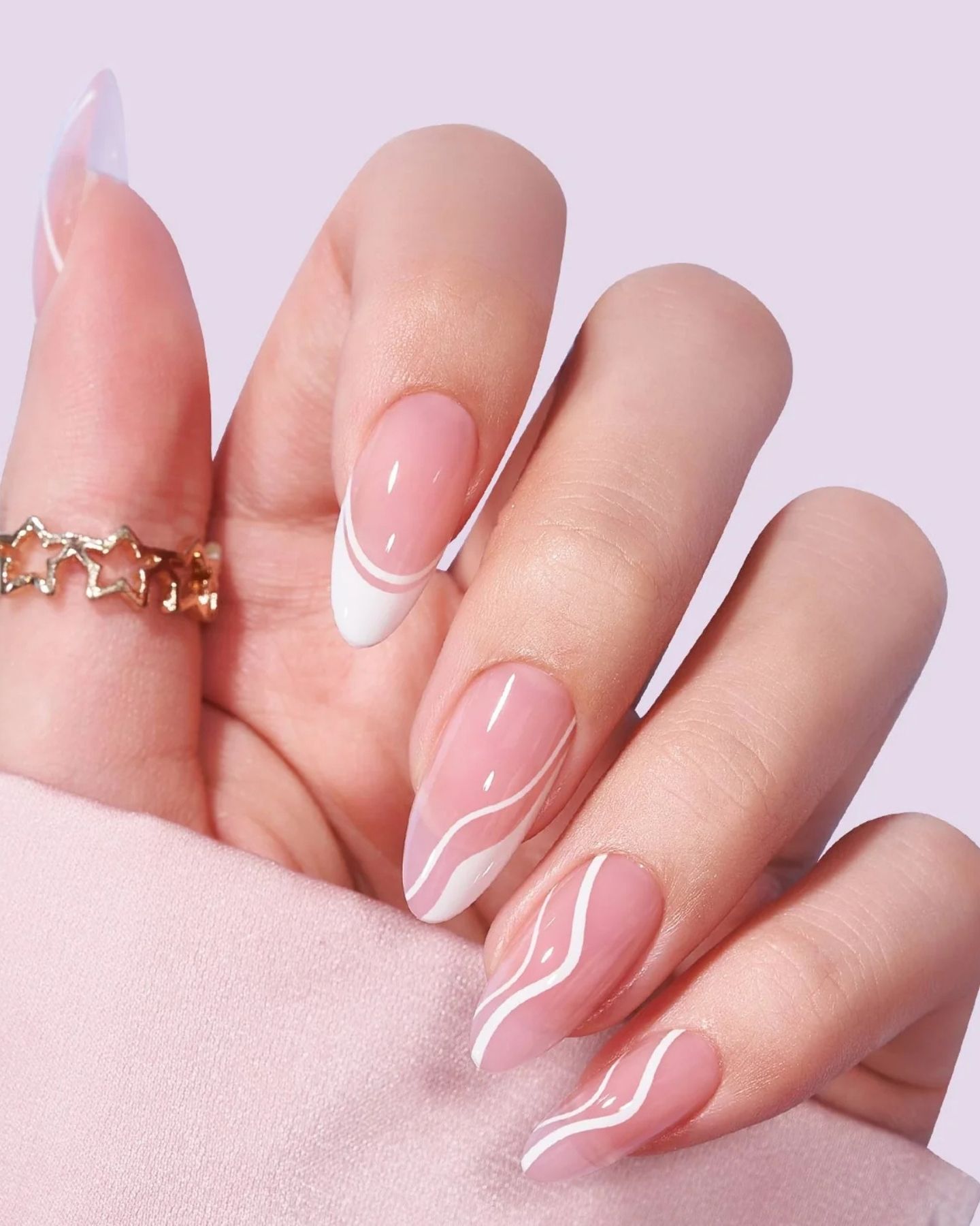 Close-up of Swirly French Nails with red and orange swirl patterns on classic French tips, combining playful color with a spring-inspired twist on a timeless design.