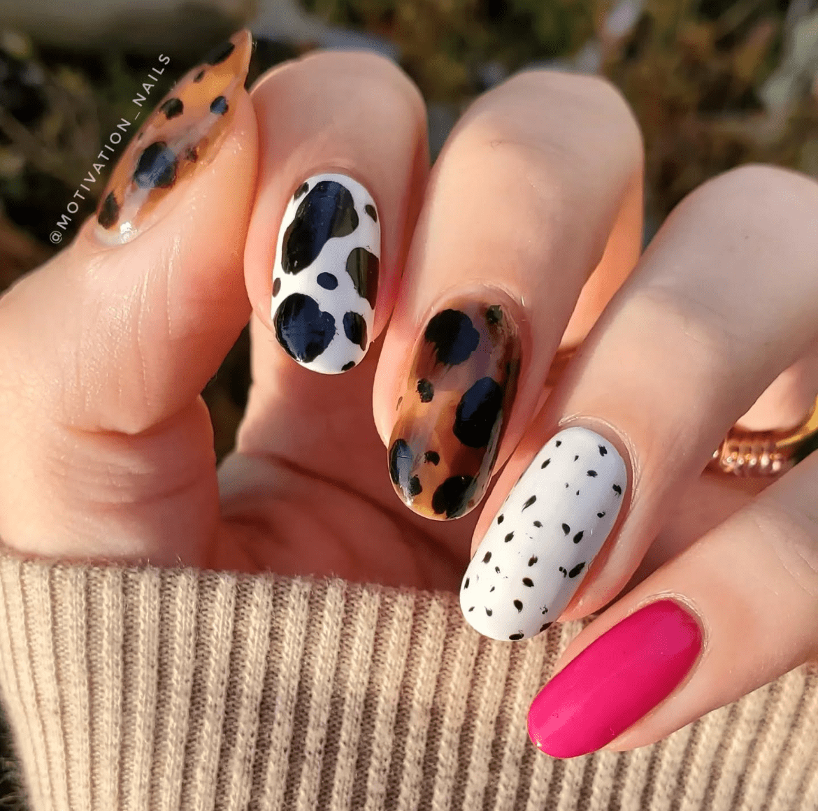 Close-up of Tortoise & Cow Print Combo nails, featuring a blend of classic tortoise shell and playful cow print patterns, with a neutral color palette for a chic, edgy look.