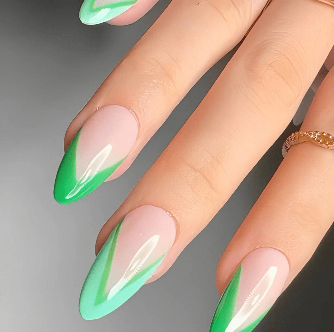 Almond-shaped nails with a glossy base and contrasting light and dark green tips in a sleek two-toned French manicure style.
