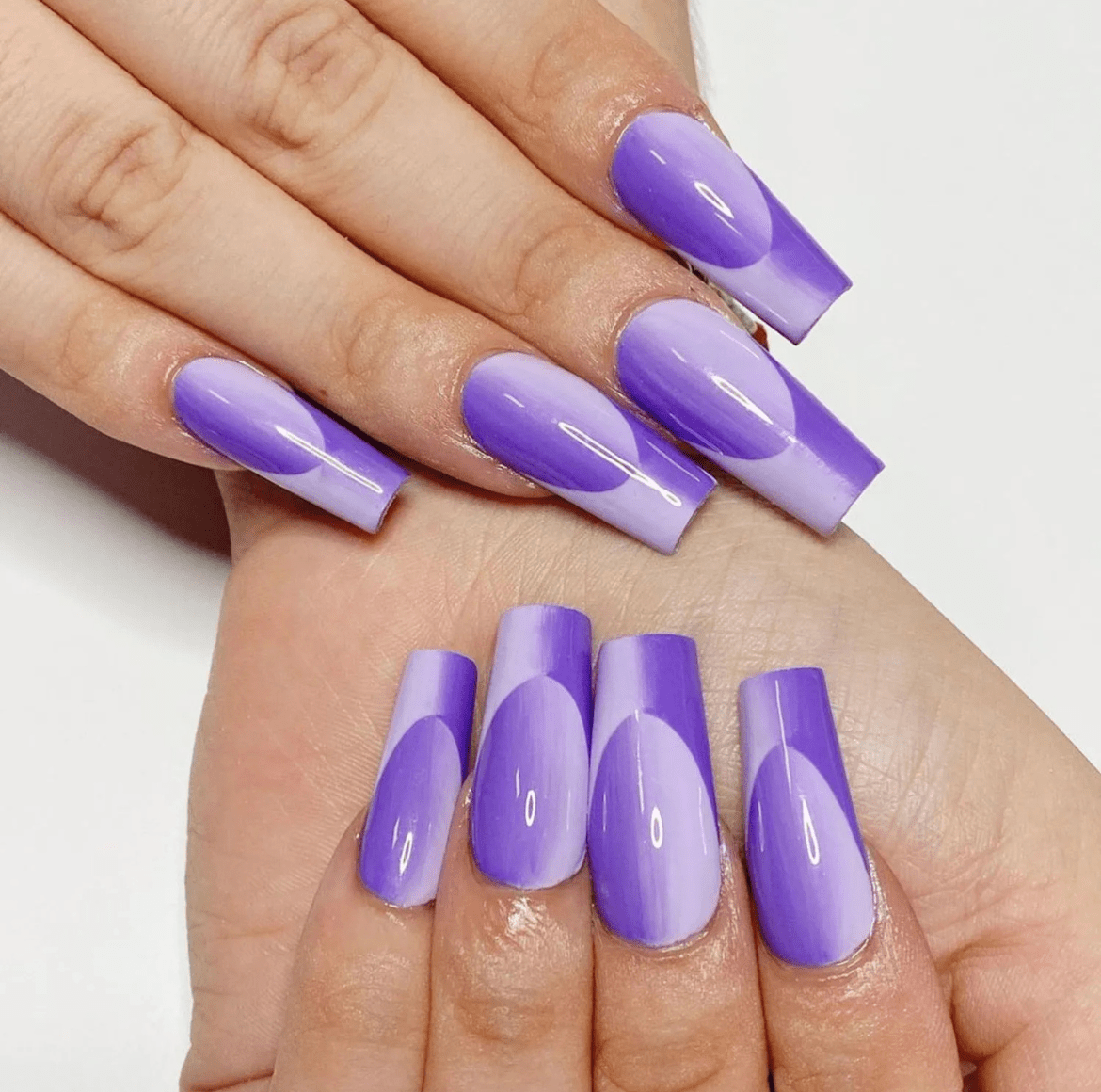 Almond-shaped nails with a 3-D double ombré French manicure in rich purple hues, creating a vibrant and dimensional effect.
