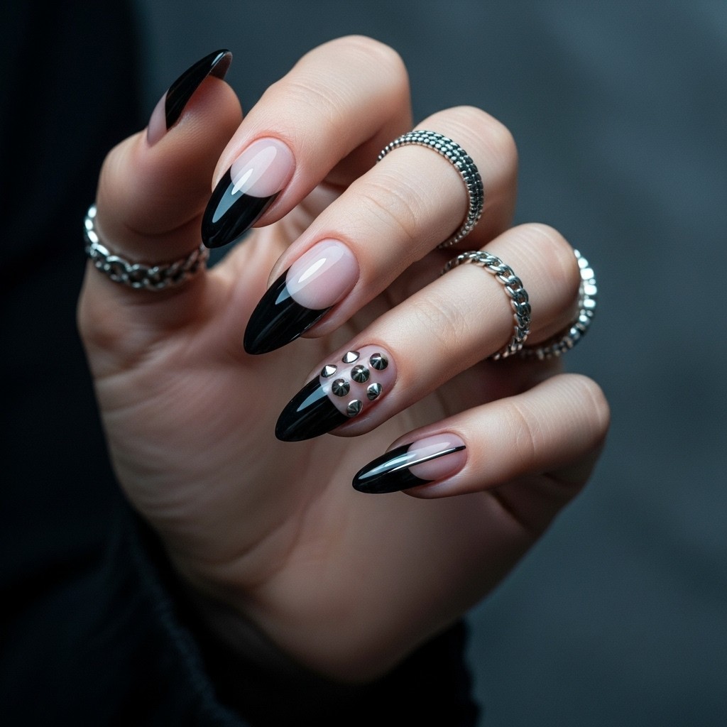 Almond nails with glossy black chrome French tips and a nude base