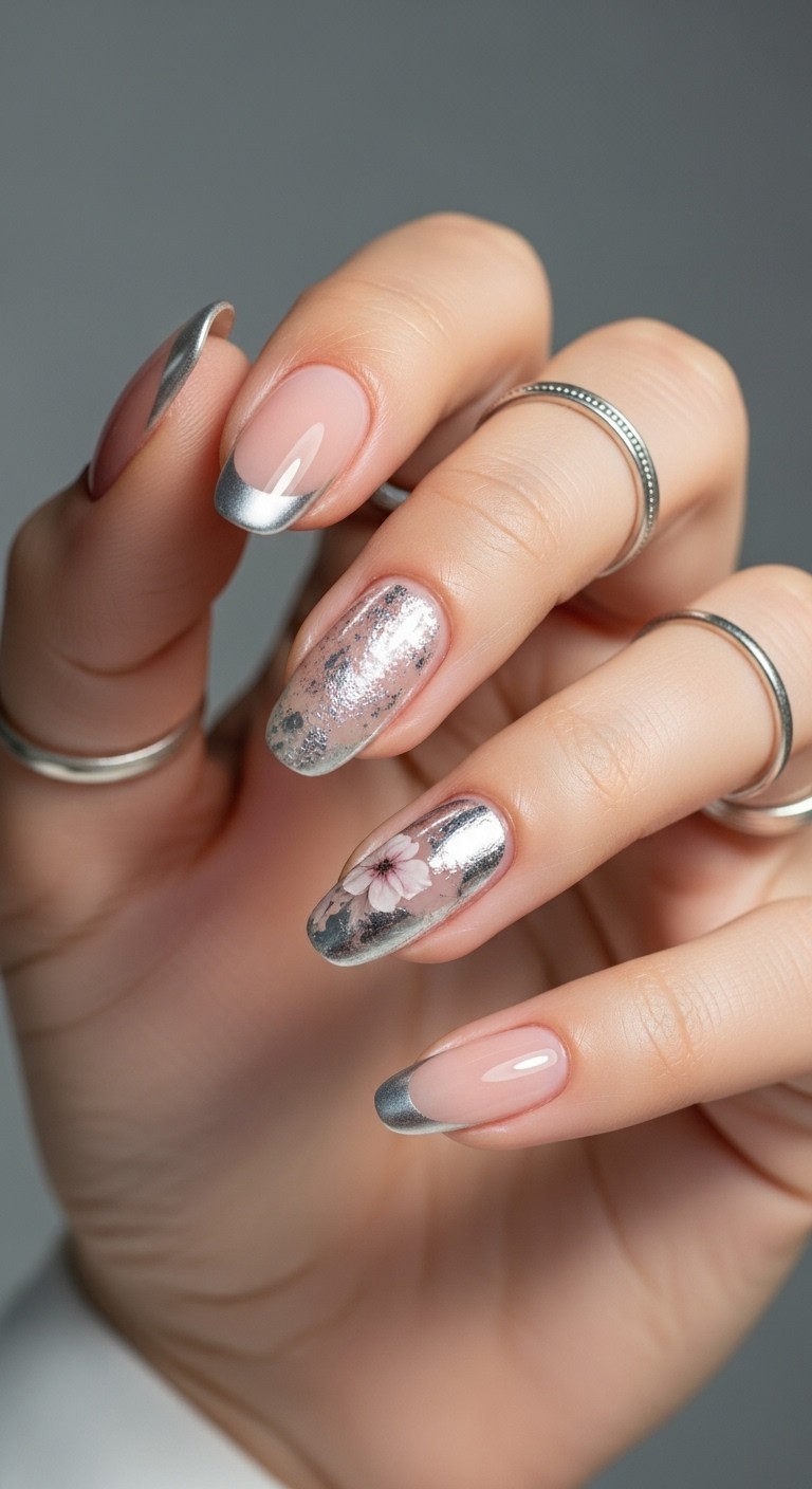 one silver-accented nail with glitter or foil detail, paired with minimalist silver French tips on the rest