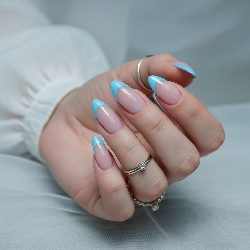 nude base and icy blue chrome French tips on a naturally posed, fully visible hand with soft lighting.