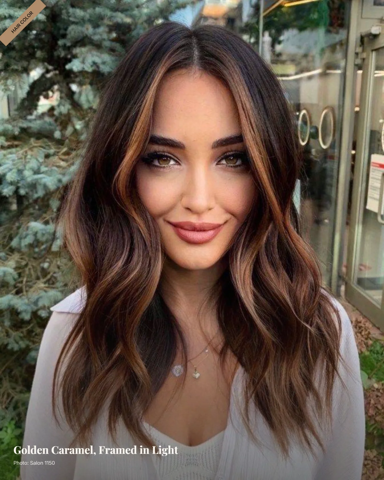 Wavy brunette hair with golden caramel balayage framing the face