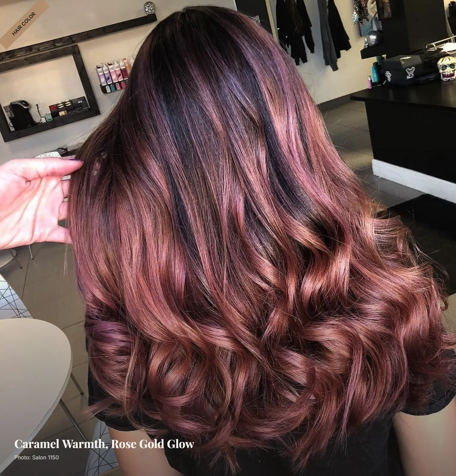 Brunette hair with caramel and rose gold balayage highlights styled in soft curls
