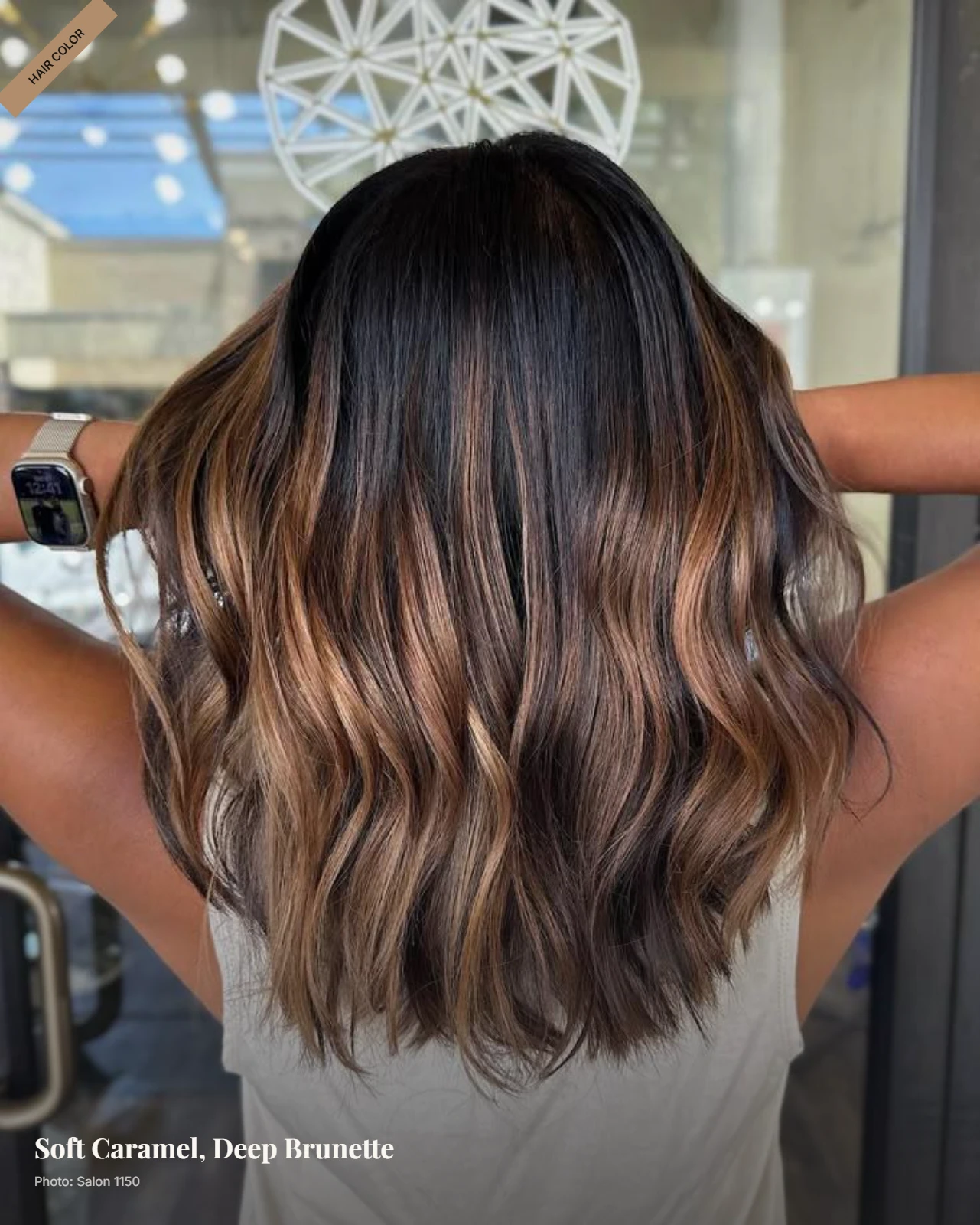 Dark brown hair with soft caramel balayage from midshaft to ends in loose waves
