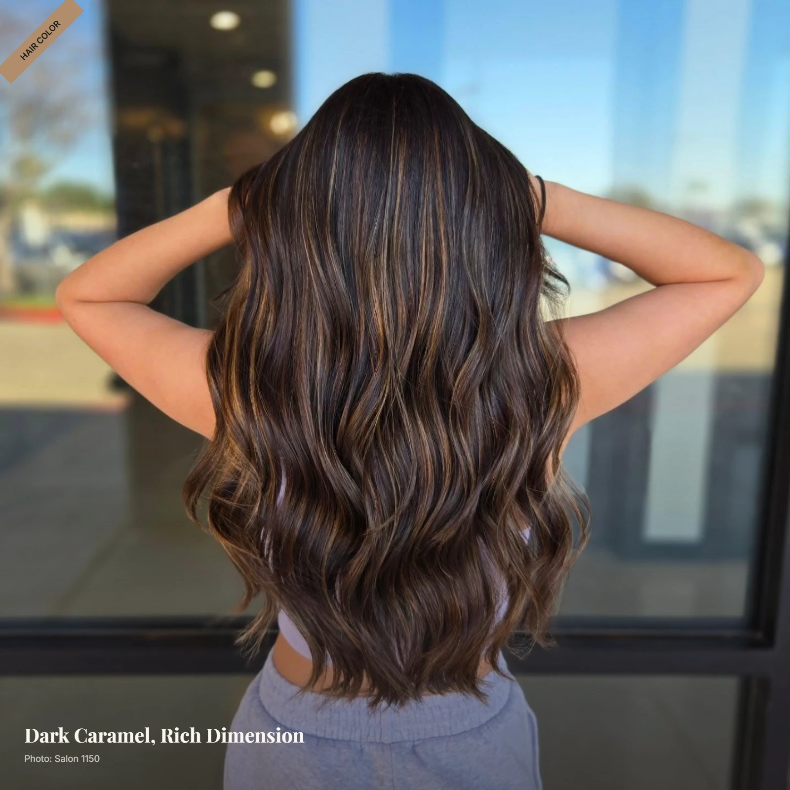 Deep brunette hair with dark caramel balayage styled in soft waves