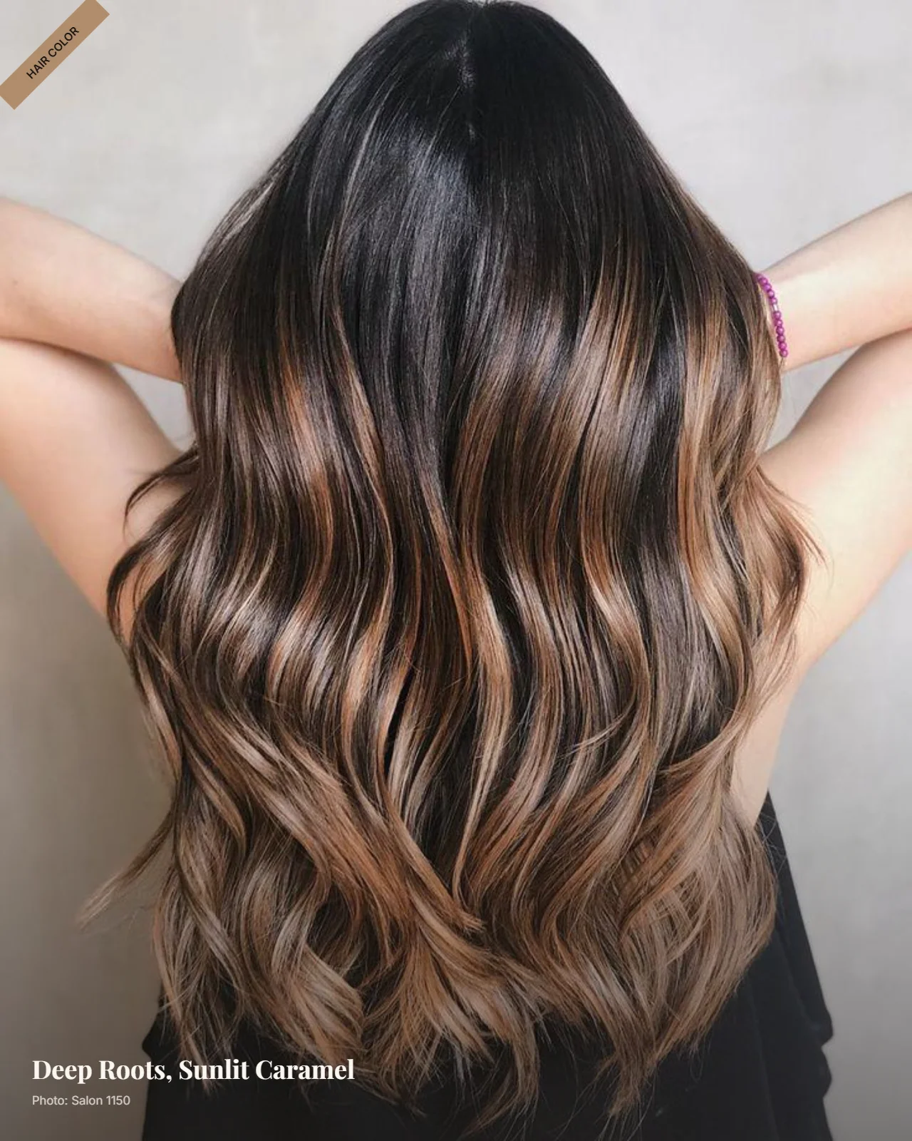 Dark brunette roots blending into warm caramel balayage ends in loose waves