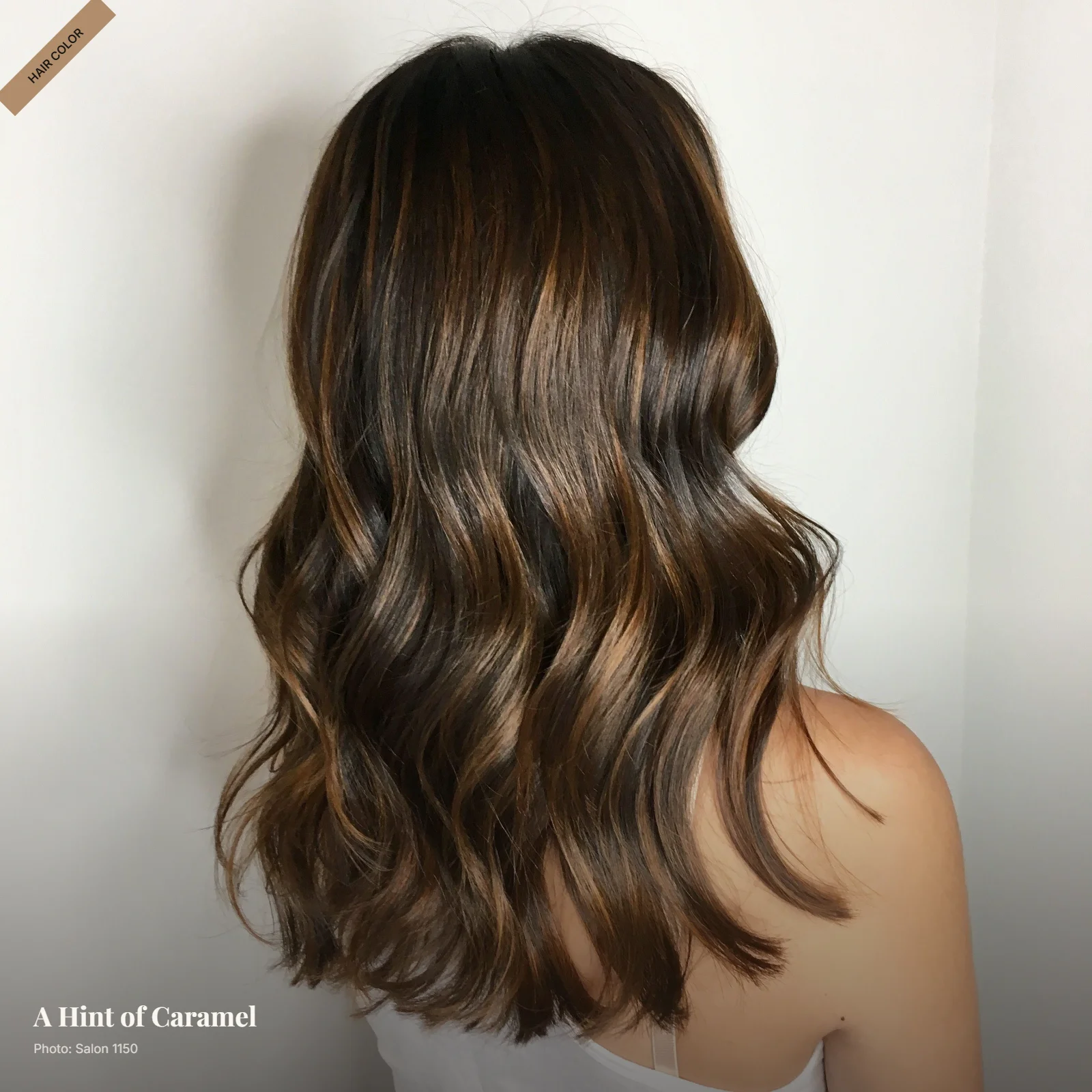 Dark brown hair with subtle caramel balayage concentrated through the lower lengths and ends