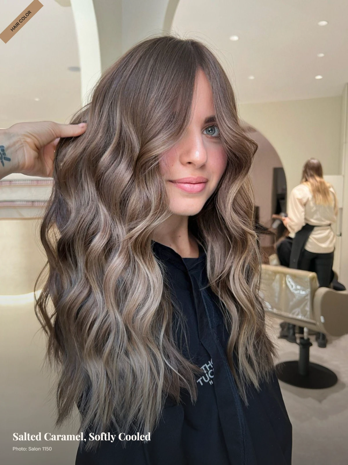 Dark brown hair with cool beige caramel balayage styled in loose waves