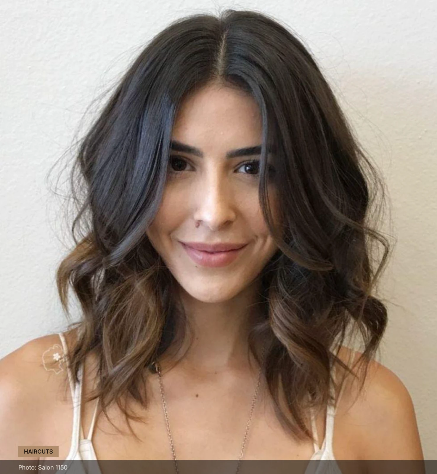 Textured crinkled lob with soft waves, center part and crown volume framing a round face