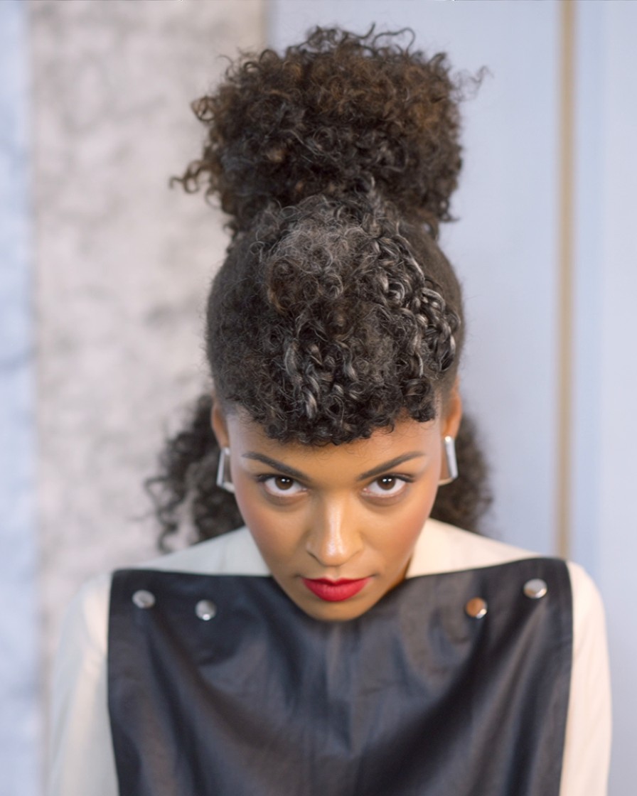 urly pompadour hairstyle, lifted volume and tight sides styled for round face shape