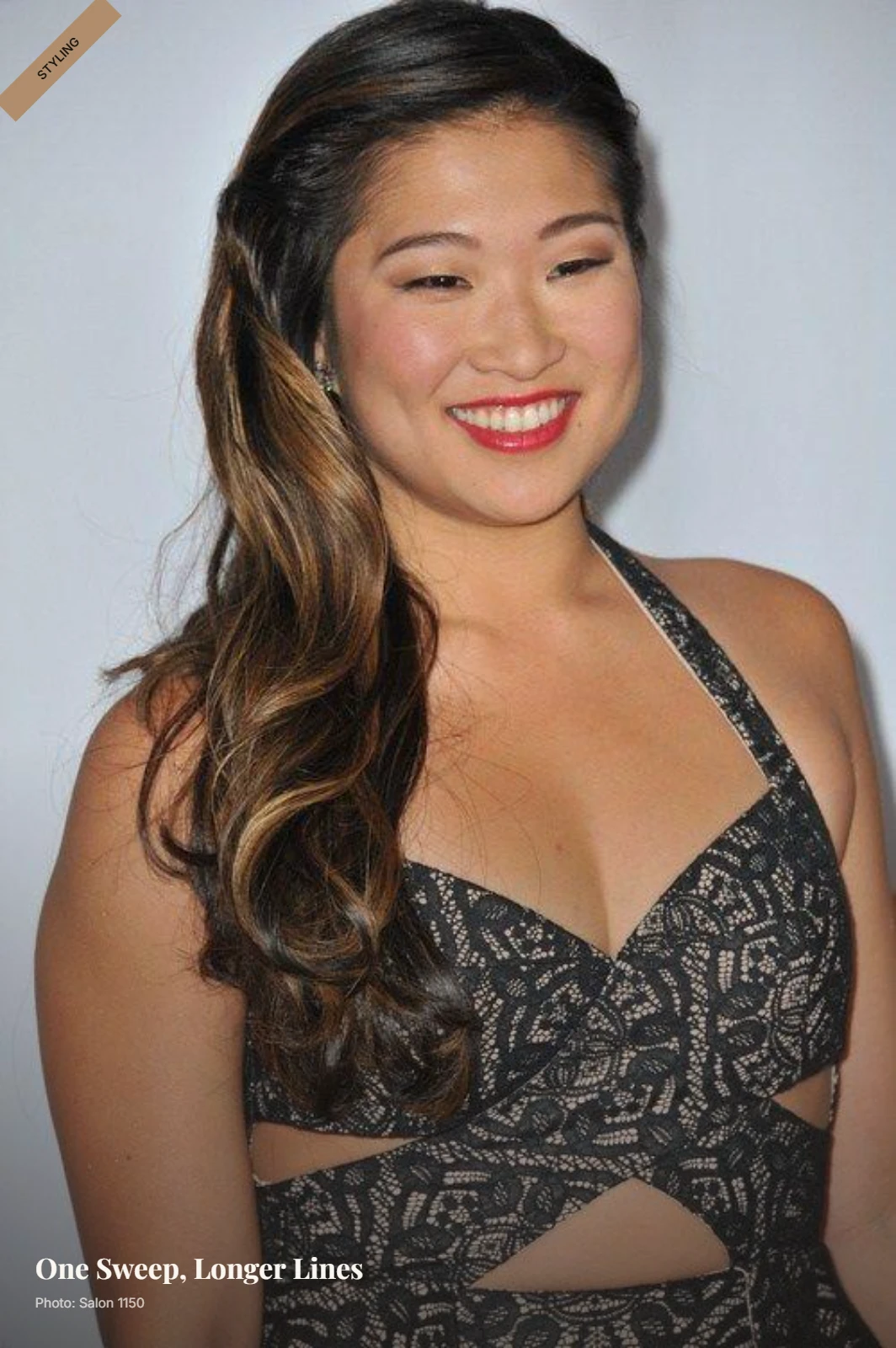Long soft waves swept over one shoulder with a deep side part framing a round face