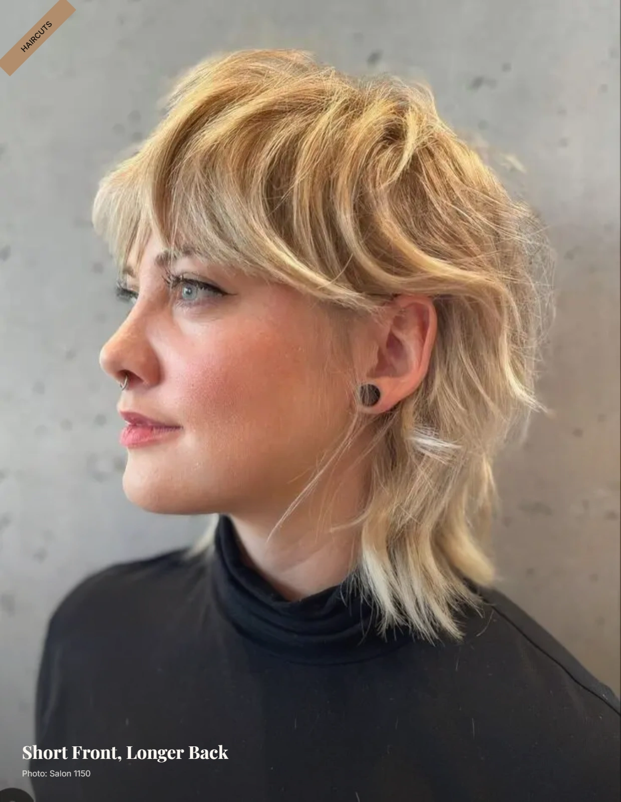 Modern mullet with cropped top, sleek sides, and longer layered back framing a round face