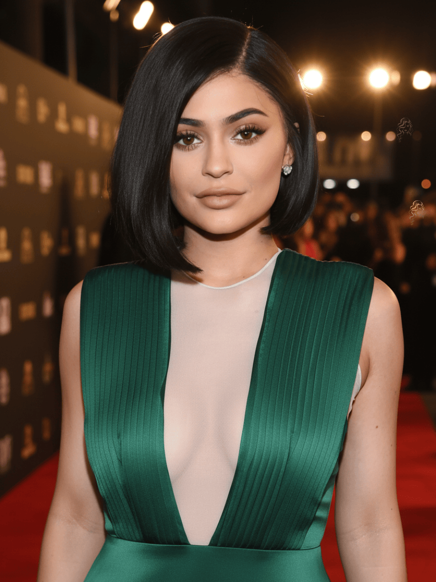 Kylie Jenner wearing a sleek angled bob hairstyle with deep side part and smooth glossy finish on the red carpet.