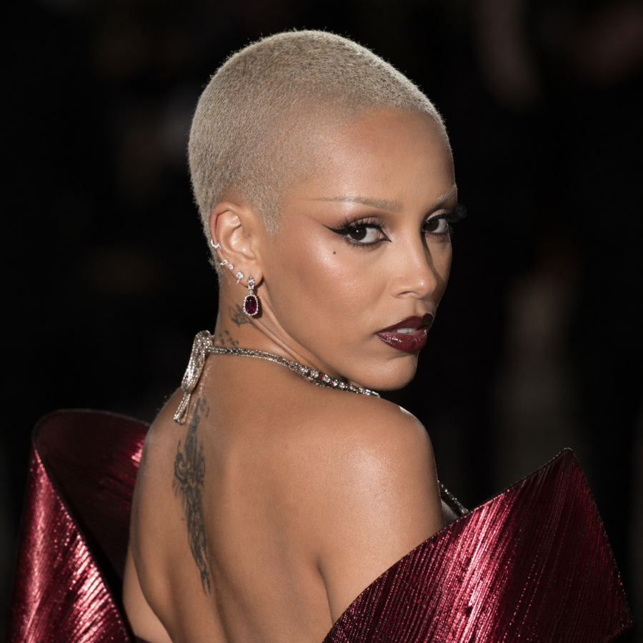 Doja Cat bleached buzz cut short hairstyle with clean minimal red carpet look