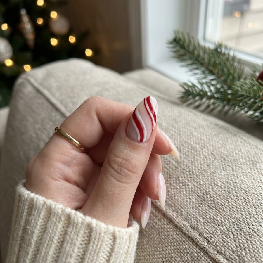 Candy cane stripe Christmas nail with red and white diagonal stripes on a soft white base