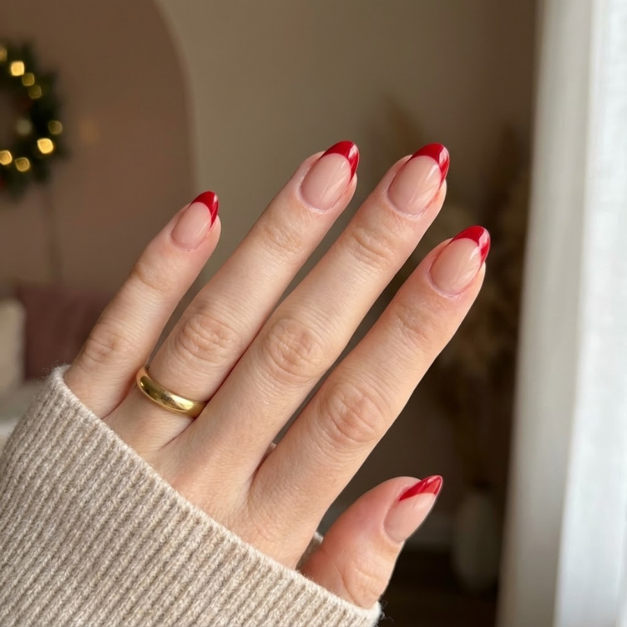 Christmas French tip nail with a sheer nude base and classic red tip for a timeless holiday manicure