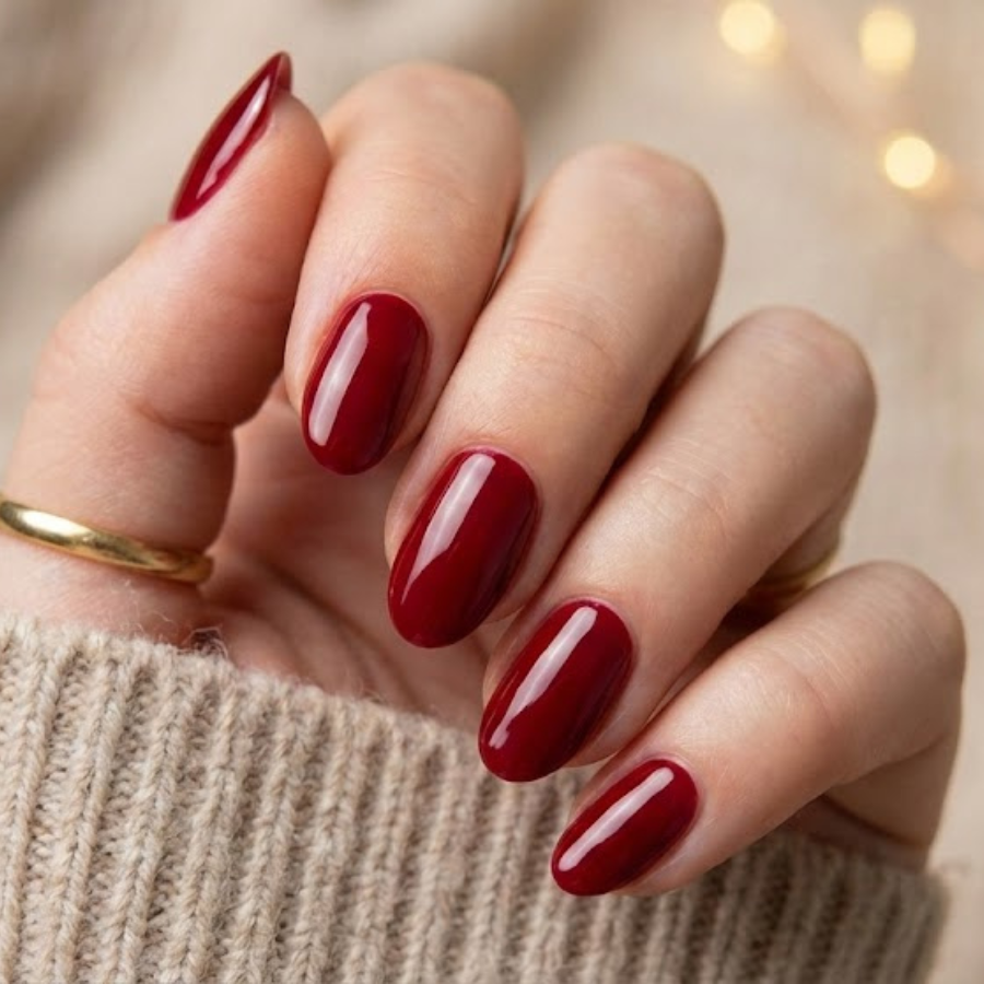 Classic red Christmas nail with a glossy finish on almond-shaped nails, styled for a timeless holiday manicure