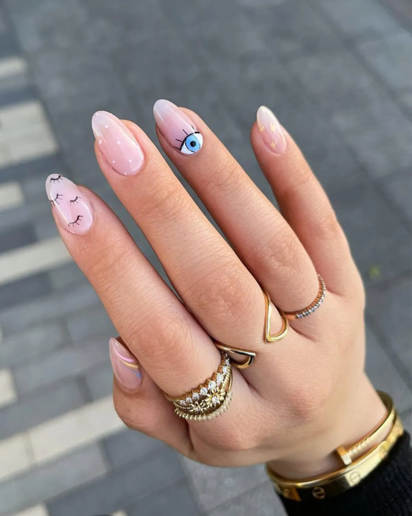 Oval nails with soft pink manicure featuring rounded tips and minimal nail art designs
