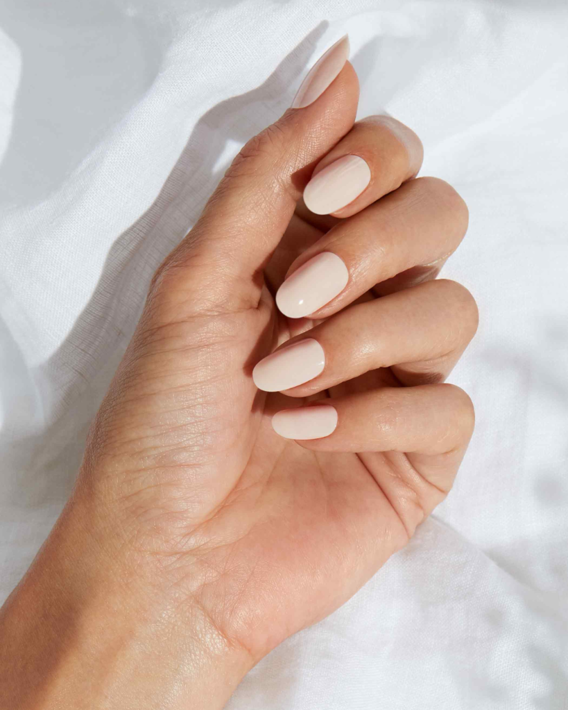 Short round nails with natural nude manicure showing smooth edges and minimal length
