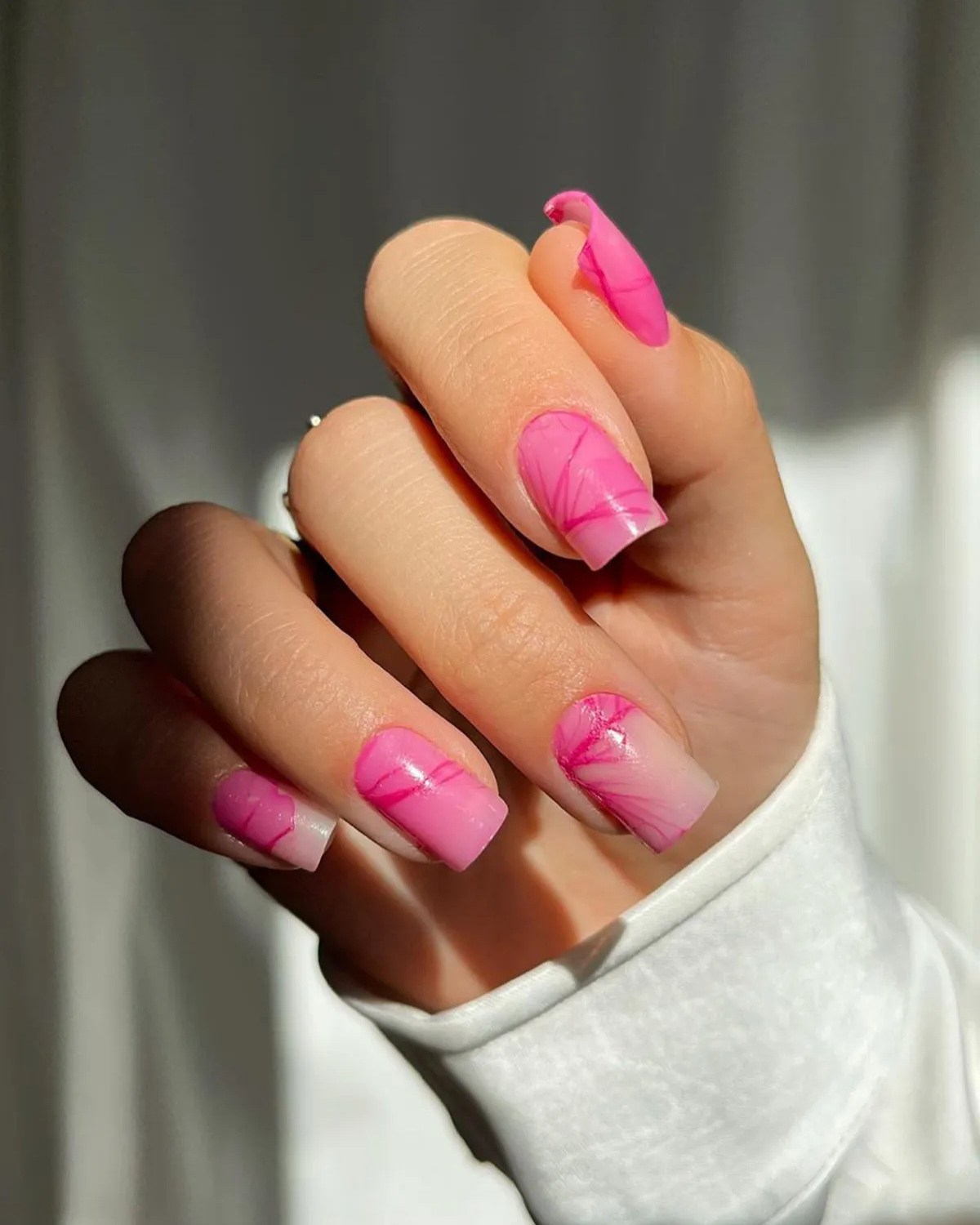 Square nails with flat tips and pink acrylic manicure showing sharp corners and straight edges
