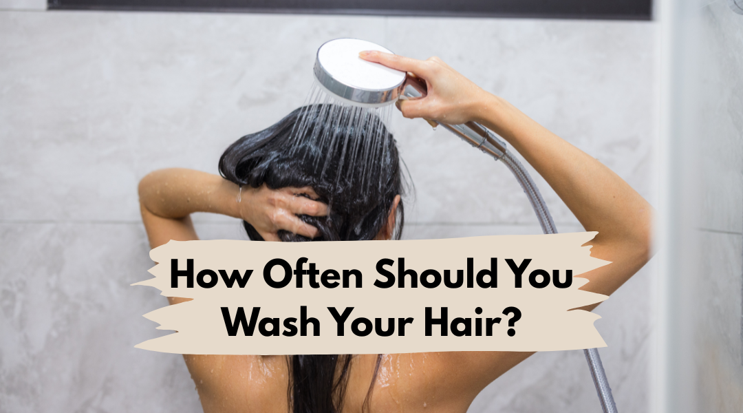 woman washing her hair in shower explaining how often you should wash your hair