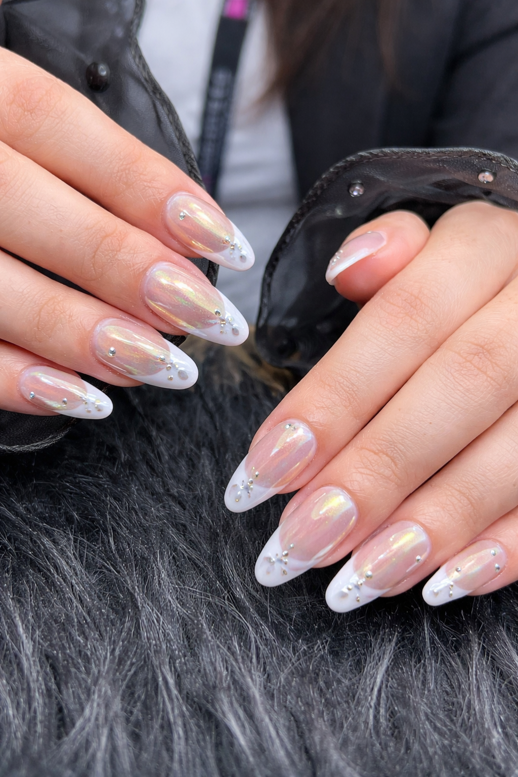 Aurora chrome french tip nails on almond shaped nails with iridescent finish and rhinestone accents