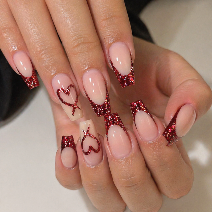 Red glitter french tip nails with heart nail art on square shaped nails and nude base