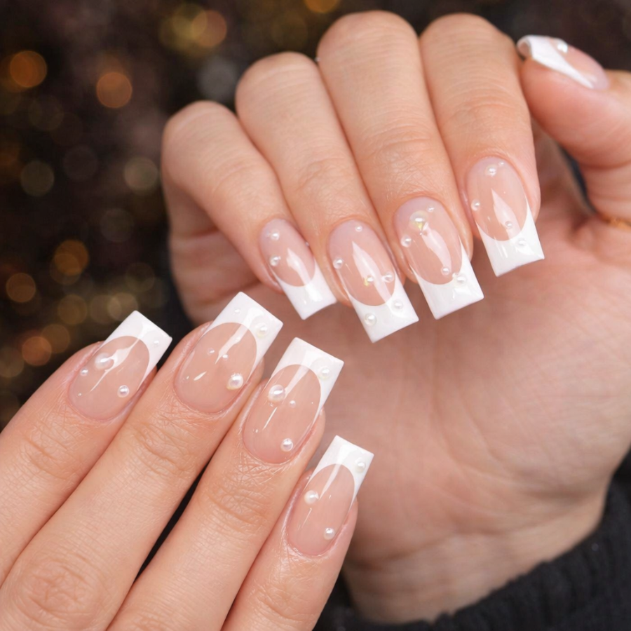 Square french tip nails with straight edge white tips on a glossy nude base with subtle pearl accents