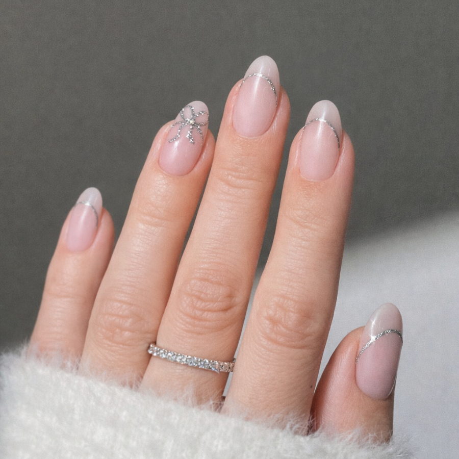 Thin silver french tip nails on almond shaped nails with a soft nude base and minimal line design