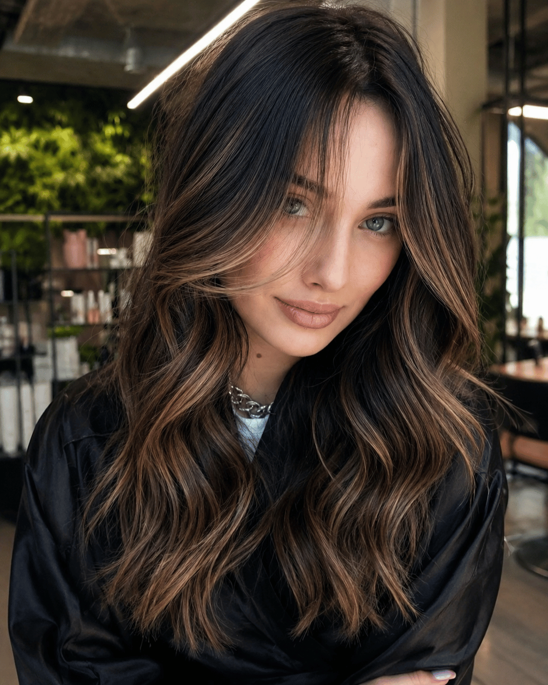 Caramel balayage on dark brown hair with soft dimensional highlights, natural root depth, and realistic warm caramel movement throughout the lengths