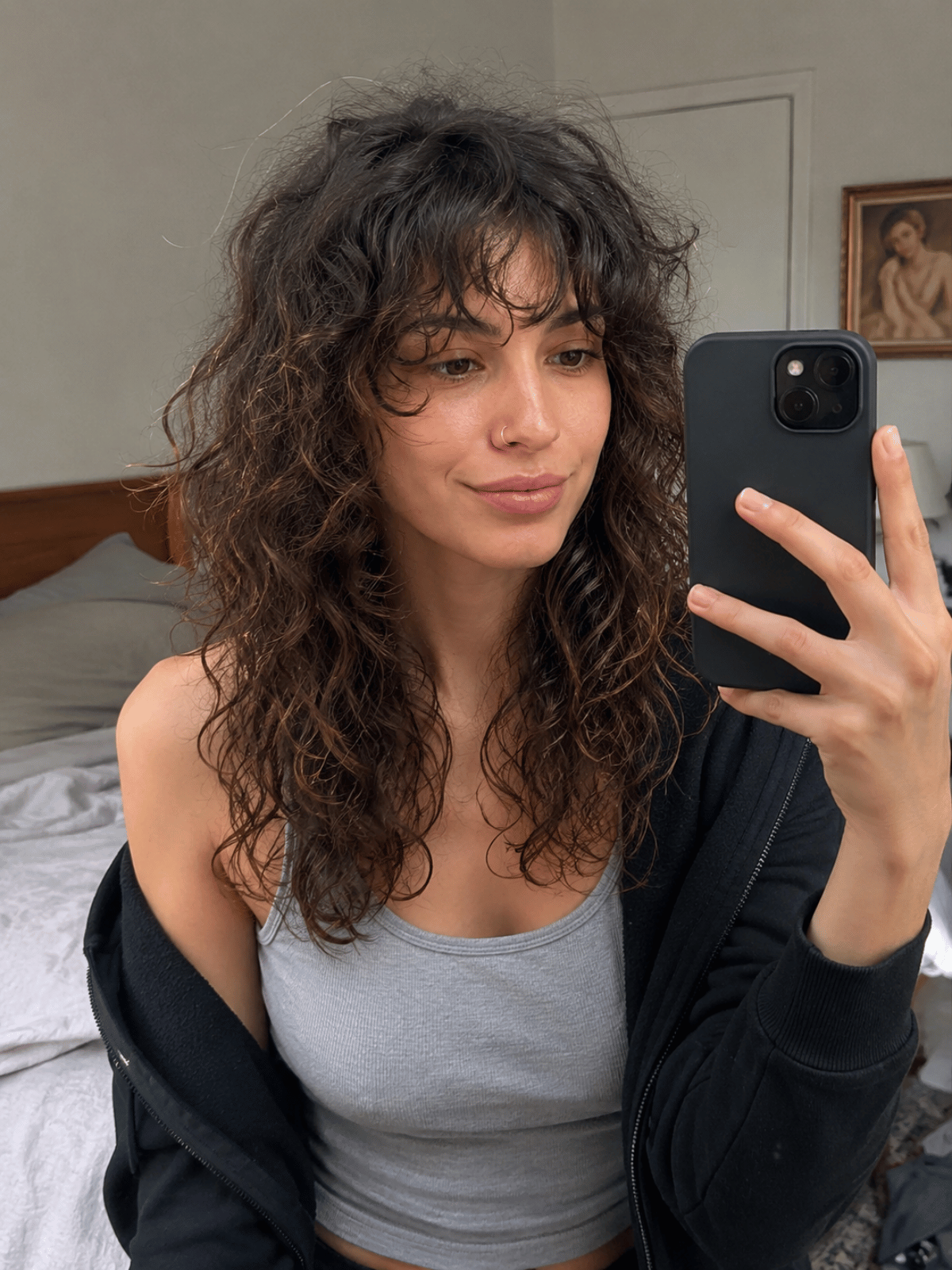 Day-three curly jellyfish haircut showing realistic lived-in texture with slight frizz and softened disconnection between wash days