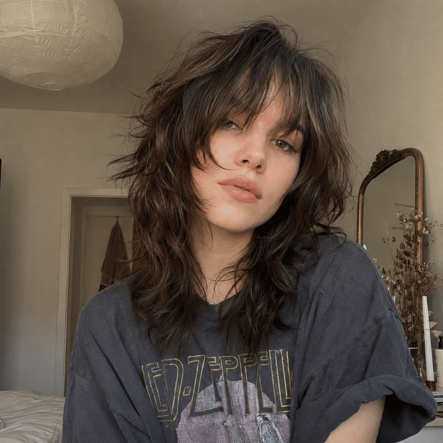 Wolf cut showing shaggy blended layers with lived-in texture and natural movement on medium-length hair
