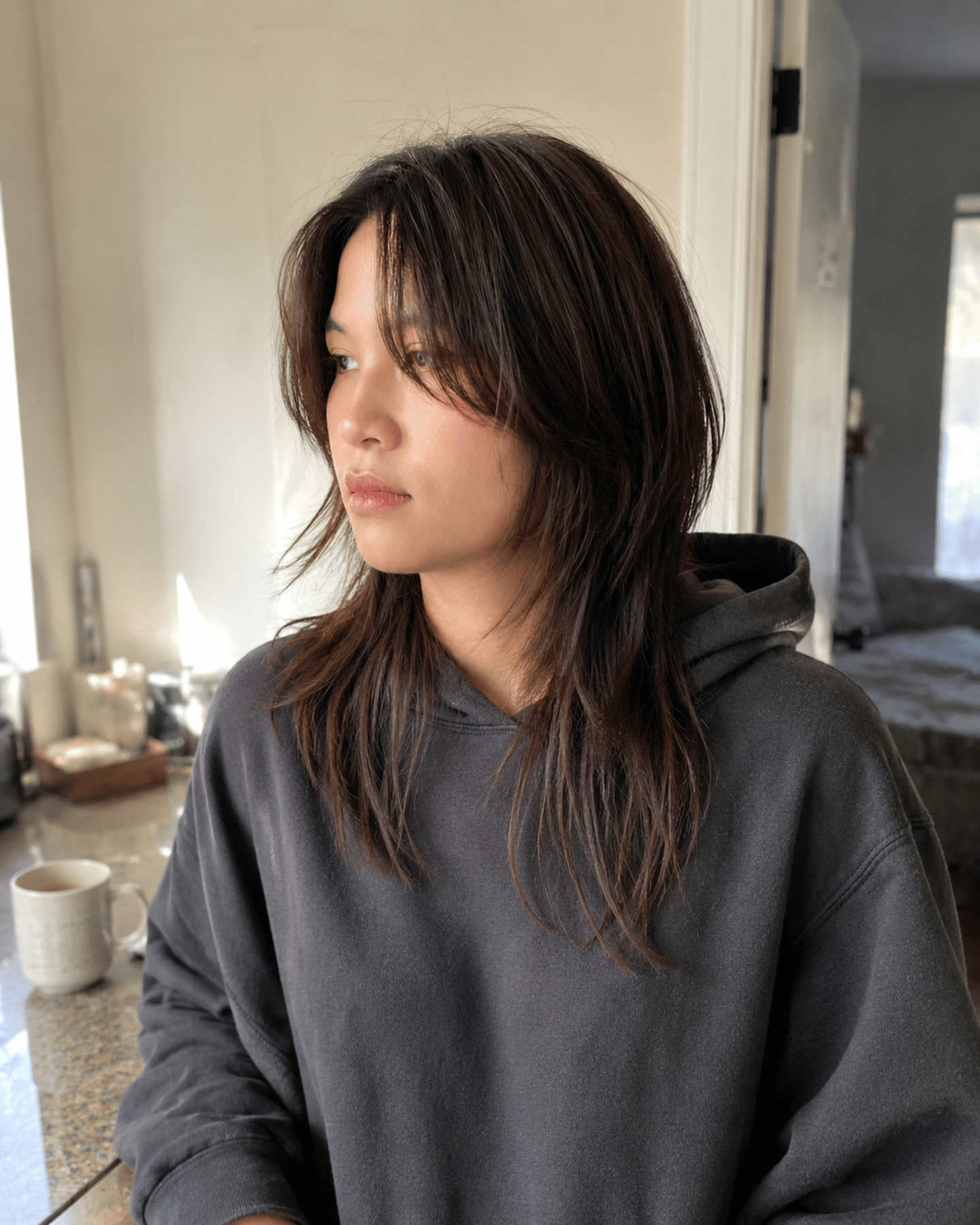 Wolf cut on straight medium-length hair showing natural lived-in texture with soft blended shaggy layers and effortless unstyled movement