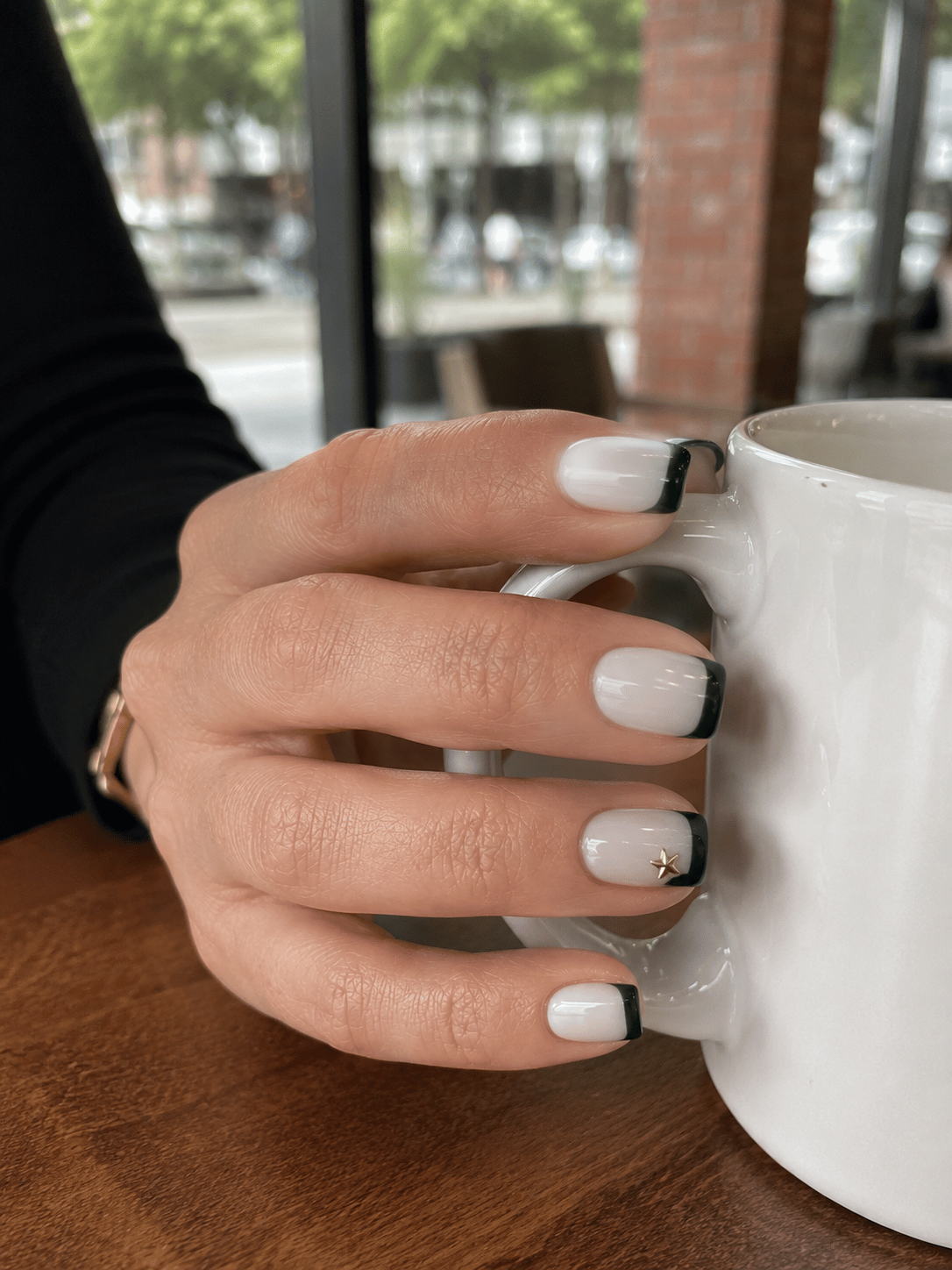 Brazil green French tip nails with short square nails and a subtle gold star accent on the ring finger