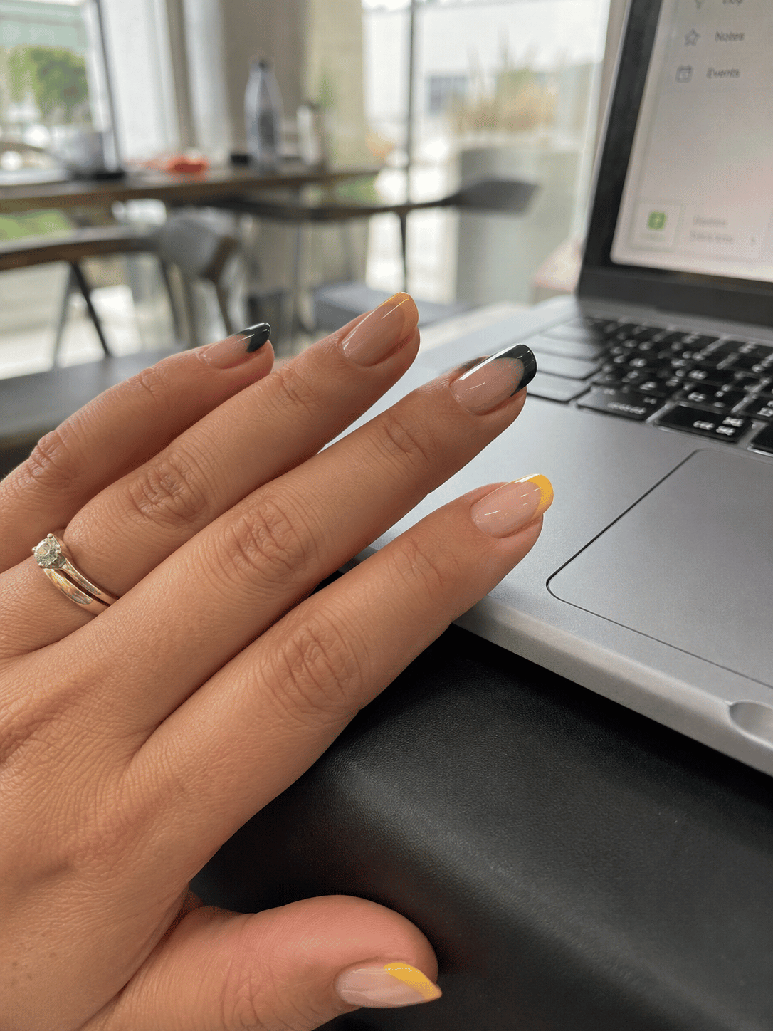Brazil French tip nails with alternating green and yellow tips on nude almond nails inspired by Brazil football colors