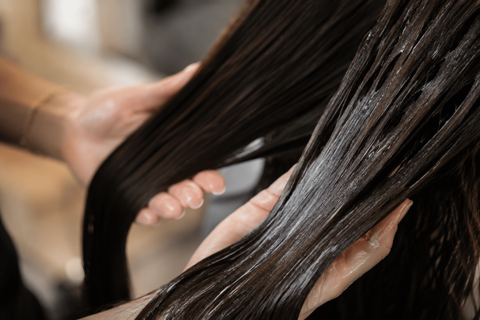 Leave-in conditioner being applied to damp hair to assess product absorption and hair porosity